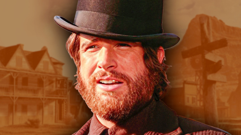 John McCabe with an Old West mining town behind him in 