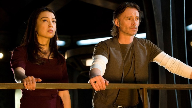 Camile Wray (Ming-Na Wen) and Dr. Nicholas Rush (Richard Carlyle) overlooking the Destiny while holding onto a railing