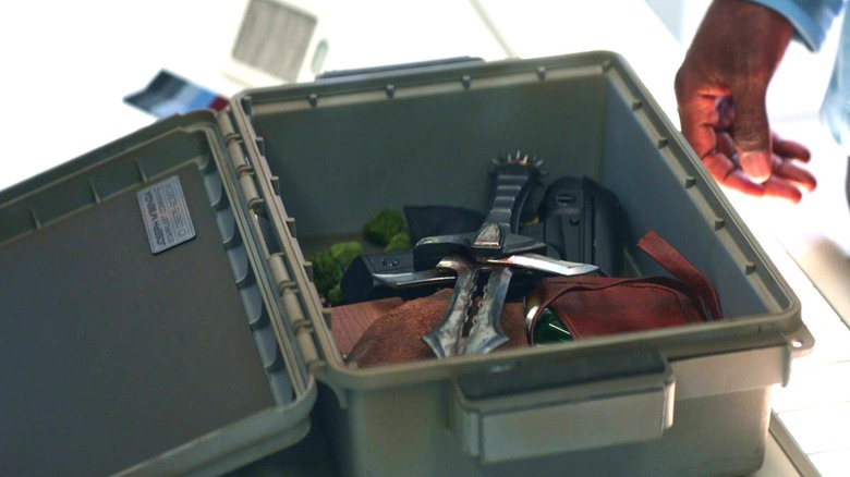 Dr M'benga's hand reaching for a knife