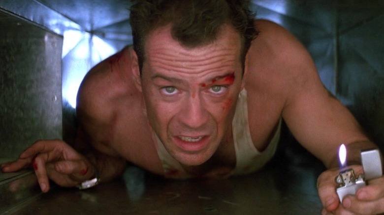 John McClane holding a lighter in Die Hard (1988)