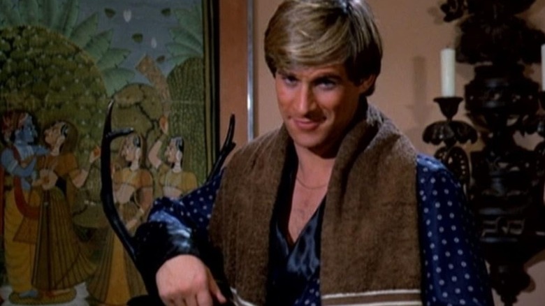 Jonathan Chase shooting a knowing look in Manimal (1983)