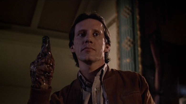 James Woods as Max Renn in "Videodrome," raising a hand that has become a fleshy gun