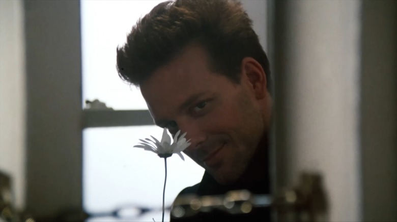 Mickey Rourke as John holding up a flower in "9½ Weeks"