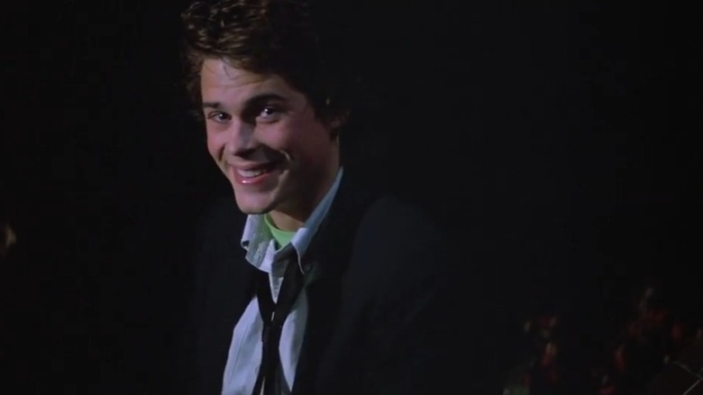 Rob Lowe sitting on a rooftop as Billy Hicks in "St. Elmo's Fire"