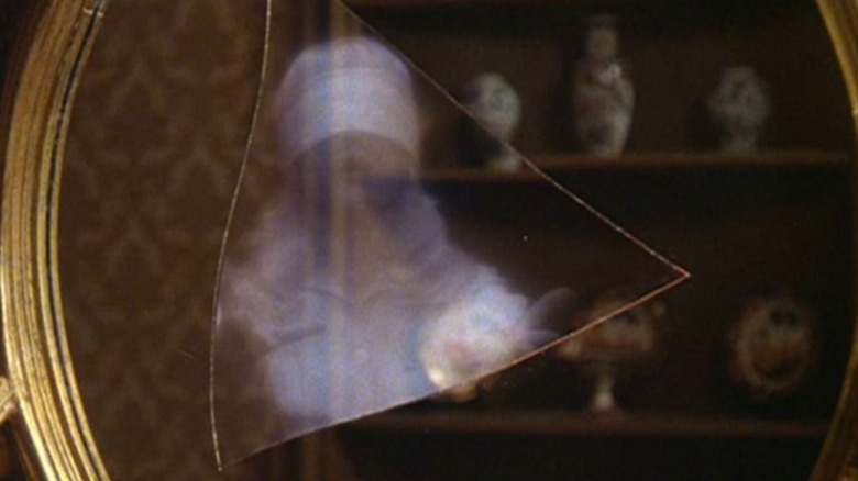 A blindfolded girl in a mirror in "The Watcher in the Woods" (1980)