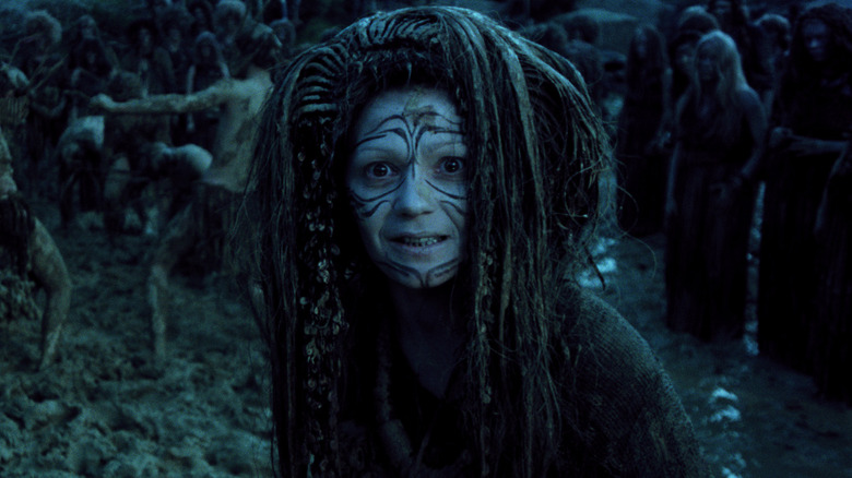an alien woman with face paint grins in On the Silver Globe (1988)