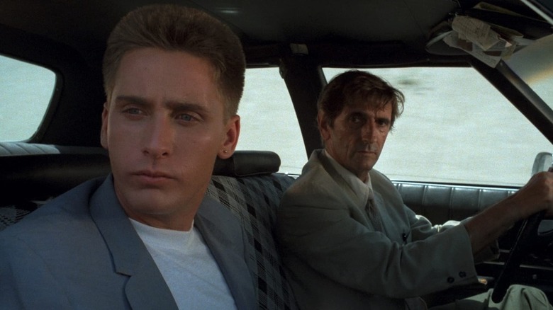 Otto and Bud, both wearing gray in a car in Repo Man (1984)