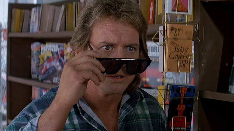 Nada lowering his sunglasses in They Live (1988)