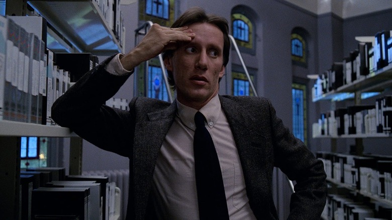 Max Renn touching his head in Videodrome (1983)