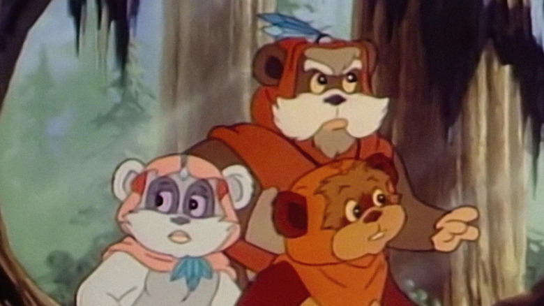 Wicket, Princess Kneesaa, and Master Logray wander through the forest in "Star Wars: Ewoks"