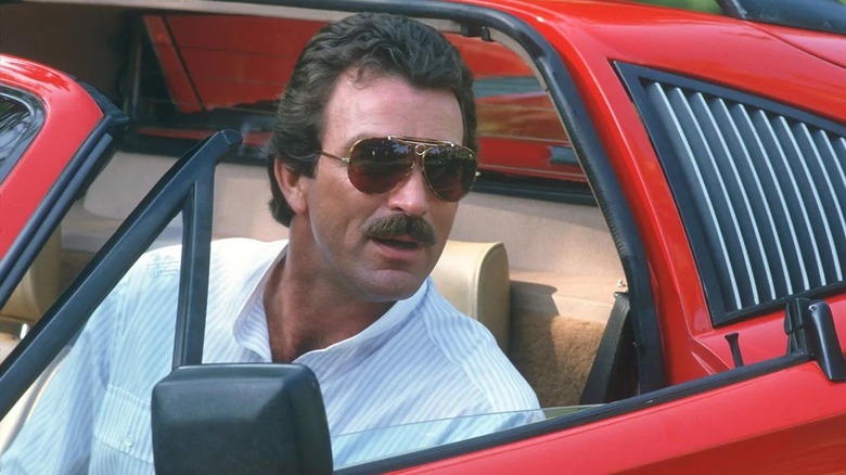 Thomas Magnum getting into a sports car wearing sunglasses in "Magnum, P.I."