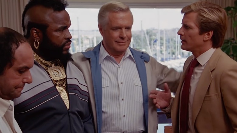 Face, Murdock, Hannibal and B.A. chat in front of a window in "The A-Team"