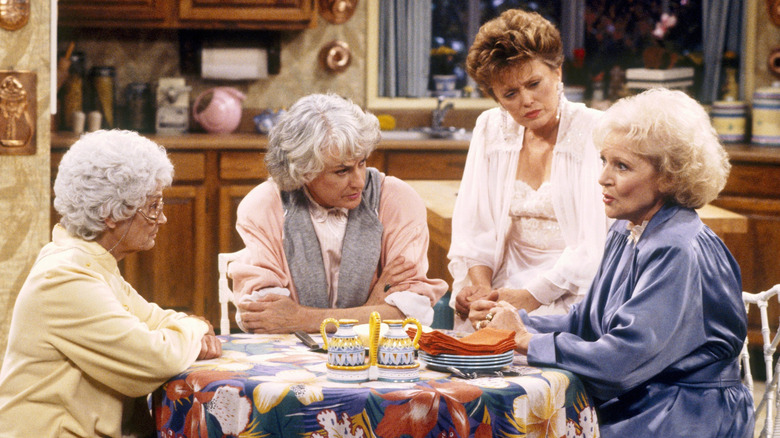 Sophia, Dorothy, Blanche, and Rose sitting around kitchen table in The Golden Girls