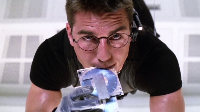 Ethan Hunt holding a drive in his mouth in Mission: Impossible