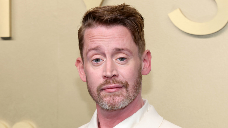 Macaulay Culkin wearing white suit