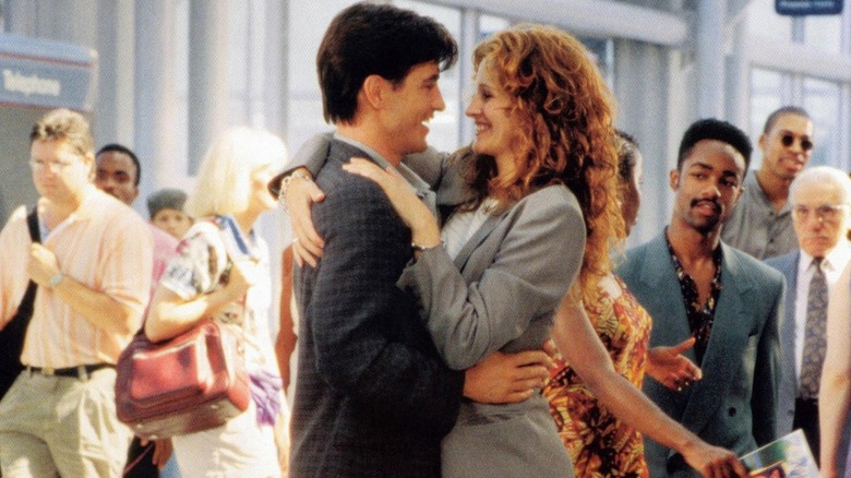 Michael greeting Julianne with a joyful embrace at the airport in 