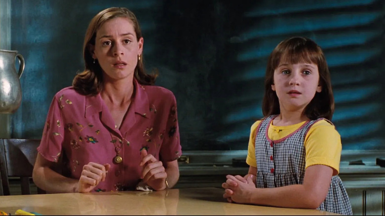 Miss Honey sits at her desk while Matilda levitates a pitcher in "Matilda" (1996)