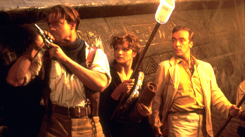 Rick, Evelyn, and Jonathan face danger in a tomb in "The Mummy" (1999)