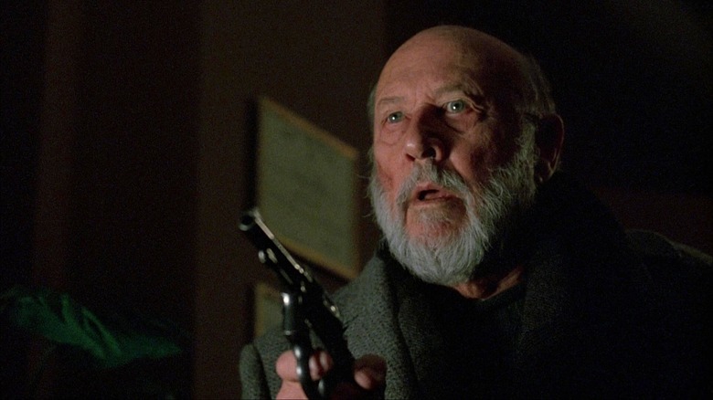 Donald Pleasance aiming gun in Halloween: The Curse of Michael Myers