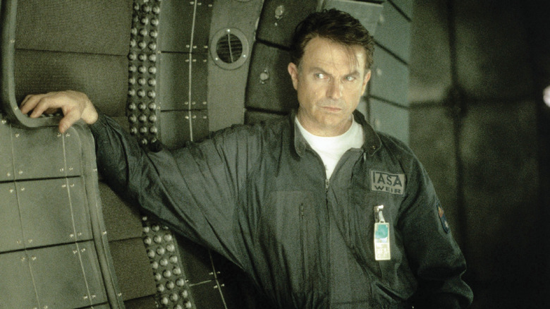 Dr. Billy Weir leaning his arm on the wall in Event Horizon (1997)