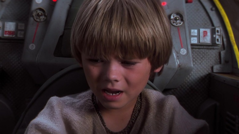 Young Anakin stares at the controls of a spaceship in "The Phantom Menace" (1999)