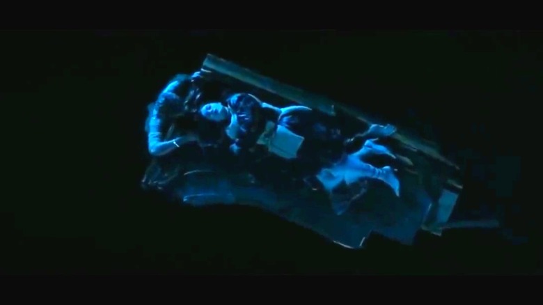 Rose floats on a door while Jack protects her in "Titanic" (1997)