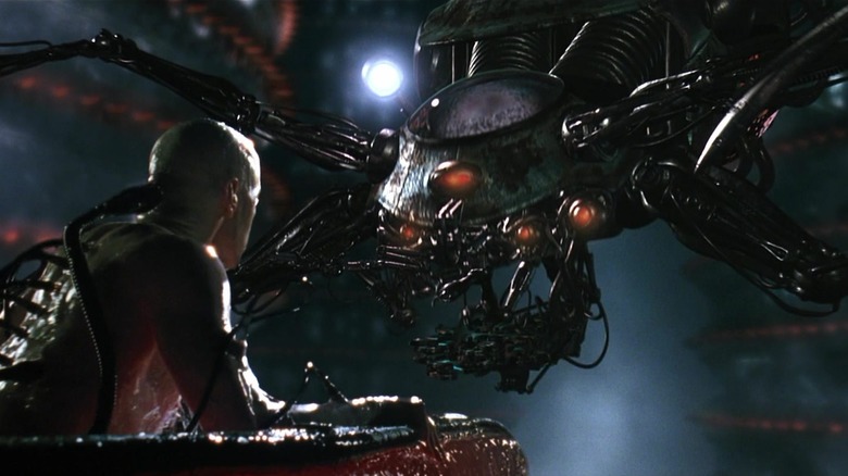 Neo awakens from his pod facing a machine in "The Matrix" (1999)