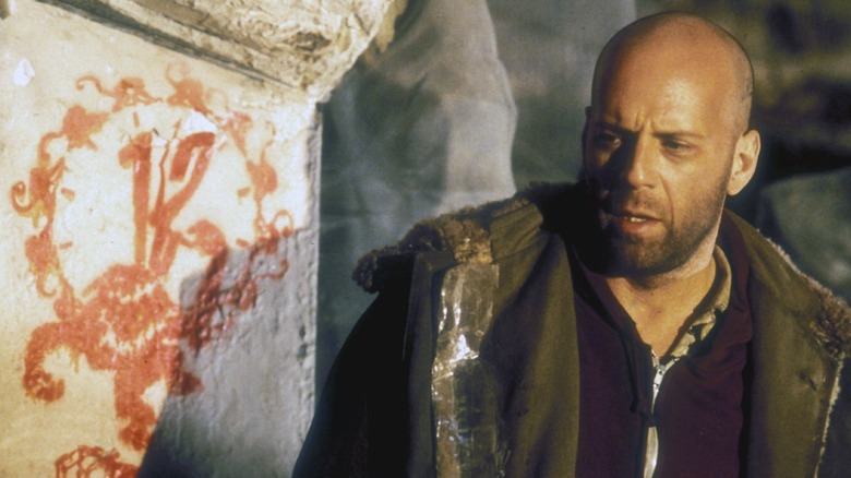 James Cole examines graffiti in "12 Monkeys" (1995)
