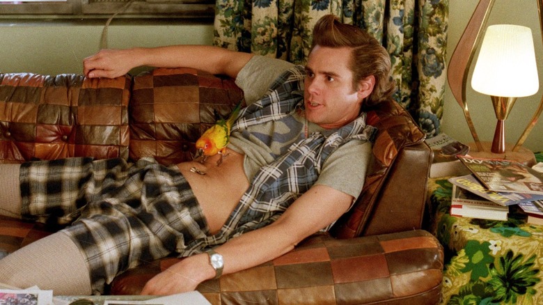 Ace Ventura sits sacked out on a couch in "Ace Ventura: Pet Detective"