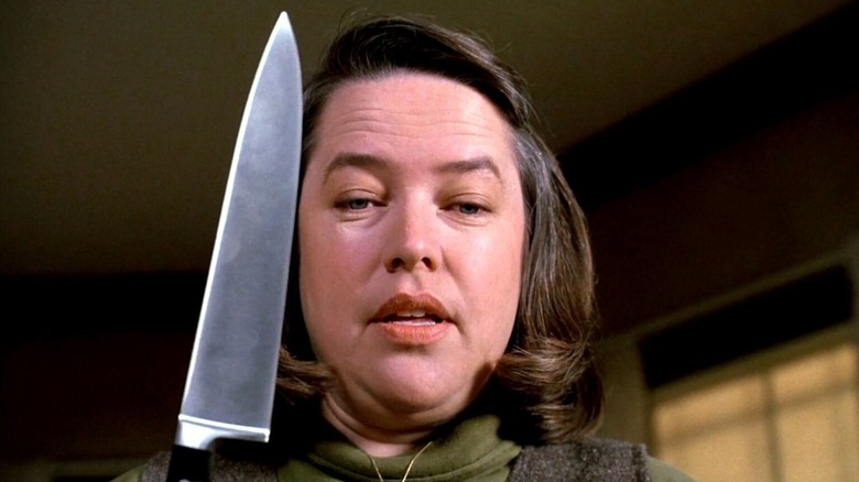 Annie Wilkes menacingly holding a knife while looking down in "Misery"
