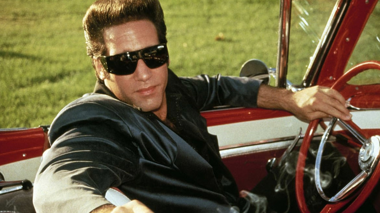 Ford Fairlane sitting in convertible in The Adventures of Ford Fairlane (1990)
