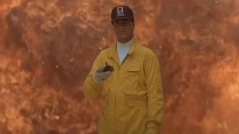 Forrest Taft walking away from an explosion in On Deadly Ground (1995)