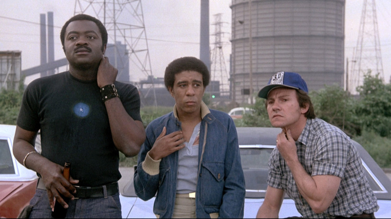 Workers sitting on a car in Blue Collar