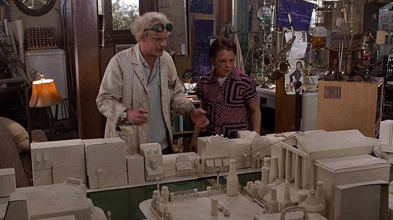 Doc Brown and Marty McFly in front of Doc's "crude" model of the town square