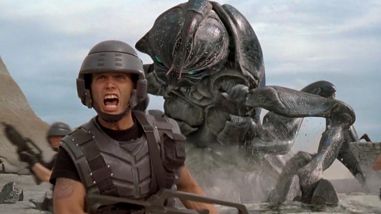 Johnny Rico (Casper Van Dien) is attacked by a giant bug in Starship Troopers