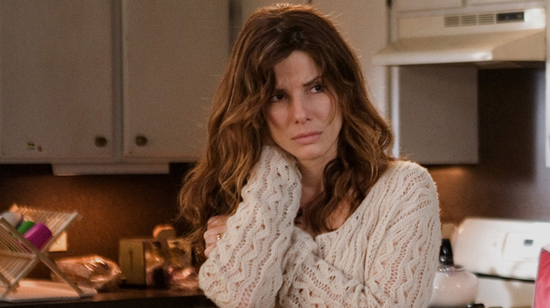 Linda stands in the kitchen looking worried in Premonition