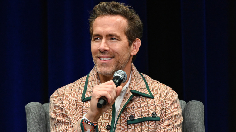 Ryan Reynolds holding a microphone