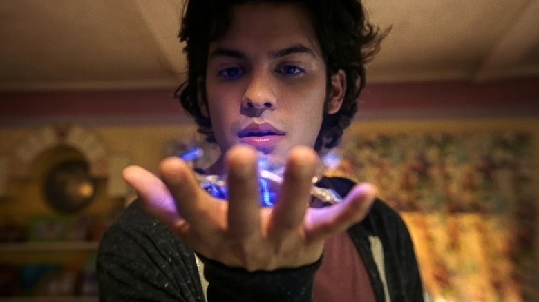 Jaime holds an alien relic in the palm of his hand in 