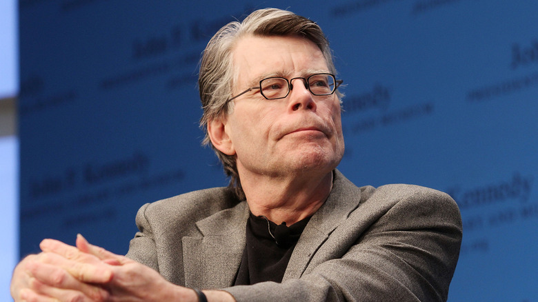 Stephen King sitting with hands on his lap