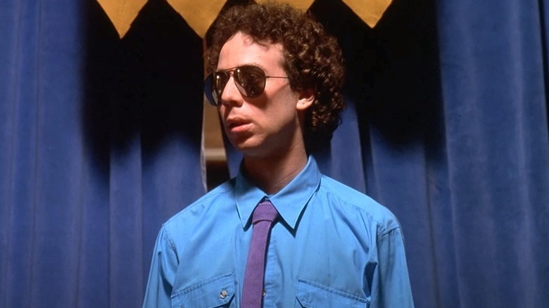 Kevin Sussman as Steve in a suit and sunglasses in 
