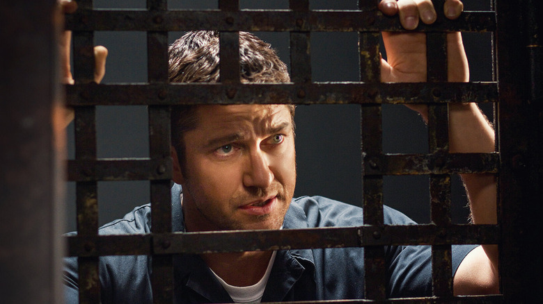 Nick looks out from behind bars in Law Abiding Citizen