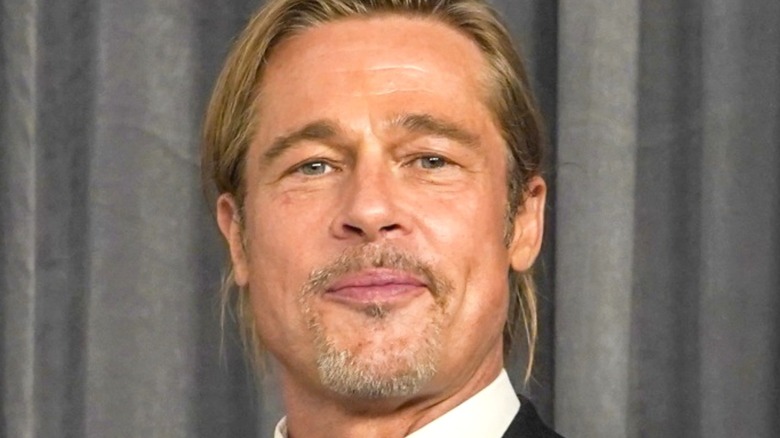 Brad Pitt smirking on red carpet