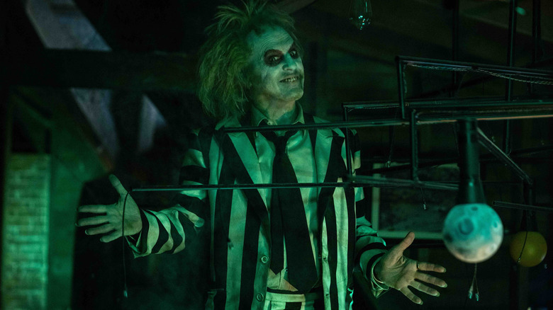 Beetlejuice posing and smiling in Beetlejuice Beetlejuice (2024)