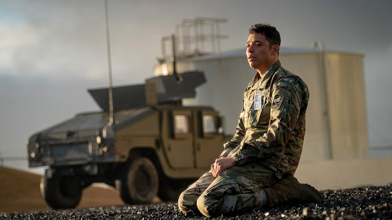 Major Daniel Gonzalez kneels in front of a military truck in "A House of Dynamite"