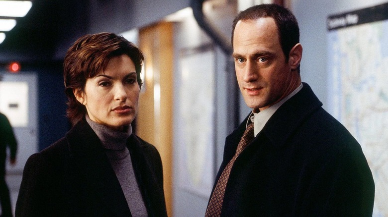 Olivia and Eliot standing together (2001)