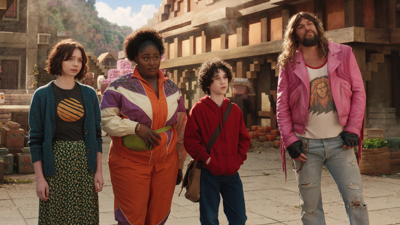 Natalie, Dawn, Henry, and Garrett in an Overworld village in A Minecraft Movie (2025)