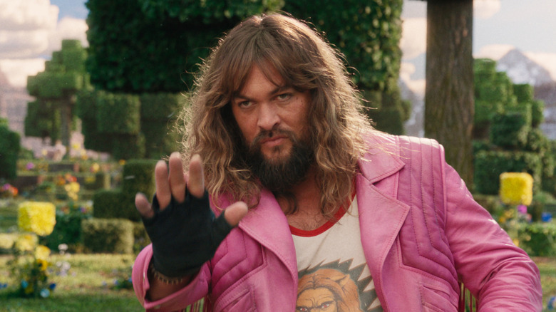 Garrett holds up his hand in the Overworld in A Minecraft Movie (2025)