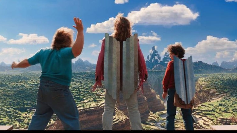 Steve waves as Garrett and Henry wear elytra in A Minecraft Movie (2025)