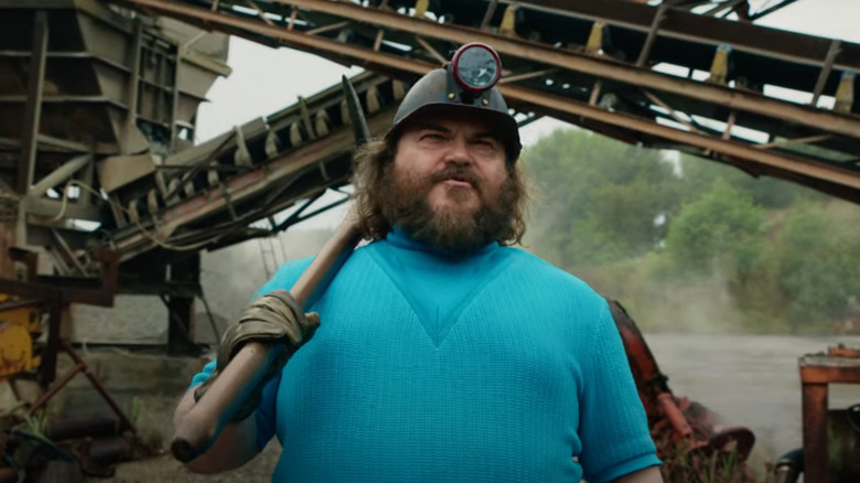 Steve holding a pickaxe in A Minecraft Movie (2025)