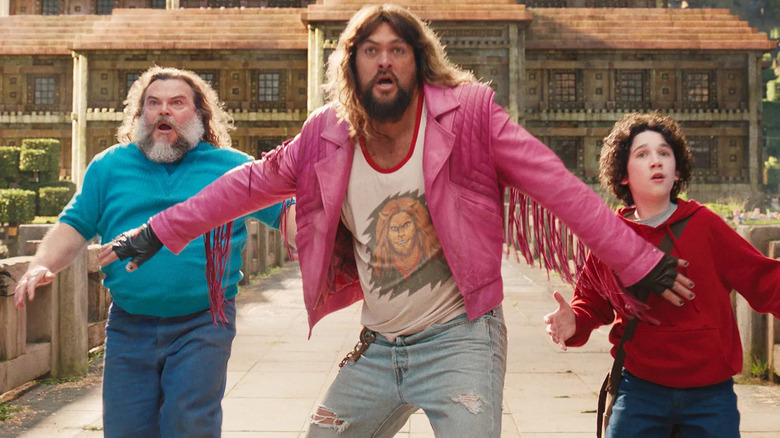 Garrett holding back Steve and Henry in A Minecraft Movie